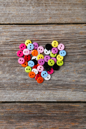 Sewing buttons on grey wooden backgroundの写真素材