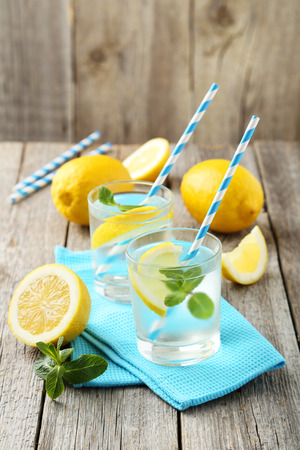 Fresh lemonade with lemon on grey wooden backgroundの写真素材