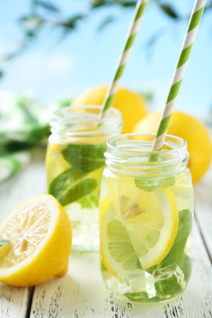 Fresh lemonade with lemon on white wooden backgroundの写真素材