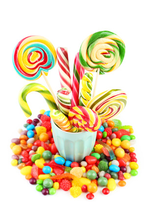 Different fruit candies in cup isolated on whiteの写真素材