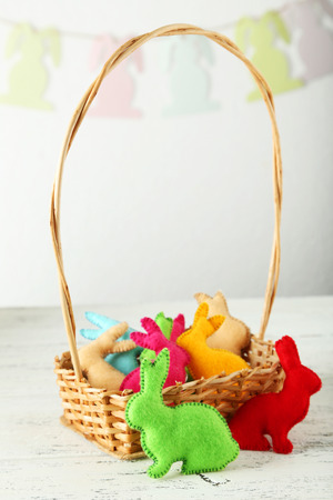 Handmade easter rabbits on white wooden backgroundの写真素材