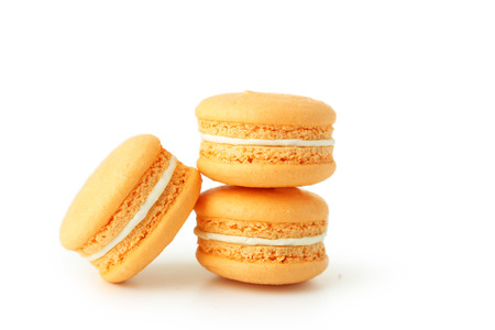 French orange macarons isolated on whiteの写真素材