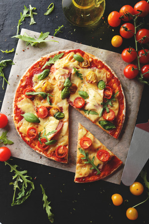 Fresh tasty pizza on black background.Toning photoの写真素材