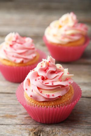 Tasty cupcake on grey wooden backgroundの写真素材