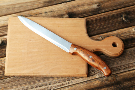 Kitchen knife on brown wooden backgroundの写真素材