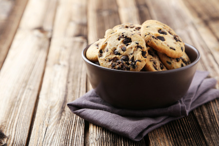 Chocolate chip cookies in bowl on brown wooden backgroundの写真素材