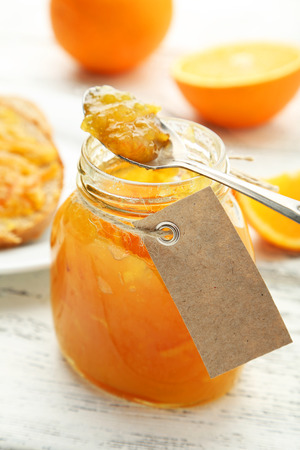Orange jam on white wooden backgroundの写真素材