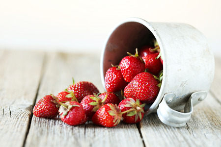 Strawberries berry in cup on grey wooden backgroundの写真素材