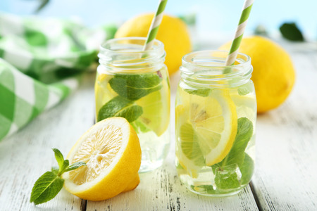 Fresh lemonade with lemon on white wooden backgroundの写真素材
