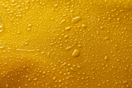 Water drops on yellow backgroundの写真素材