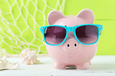 Pink piggy bank on white wooden backgroundの写真素材