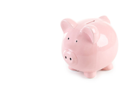 Pink piggy bank isolated on a whiteの写真素材