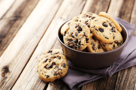 Chocolate chip cookies in bowl on brown wooden backgroundの写真素材