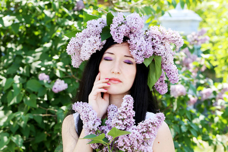 Young woman with lilac wreathの写真素材