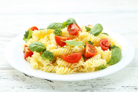 Delicious pasta on plate on white wooden backgroundの写真素材