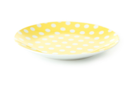 Yellow saucer isolated on a whiteの写真素材