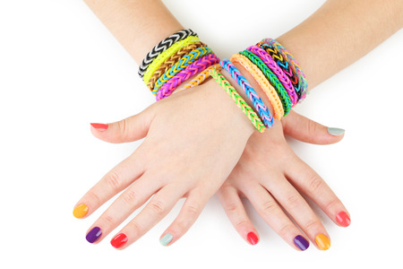 Loom bracelets on hands of young girlの写真素材