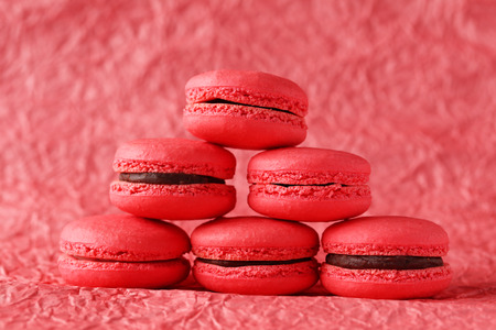 Red macarons on red paper backgroundの写真素材