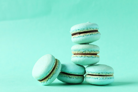 Tasty macarons on green paper backgroundの写真素材