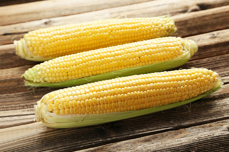 Corns on a brown wooden backgroundの写真素材