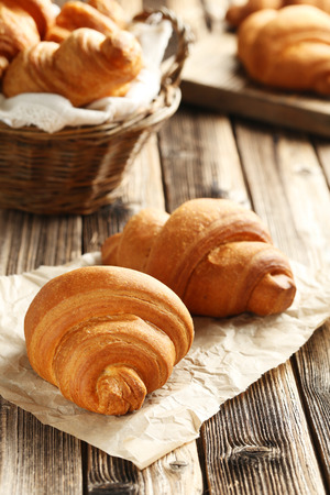 Tasty croissants on brown wooden backgroundの写真素材