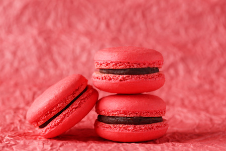 Red macarons on red paper backgroundの写真素材
