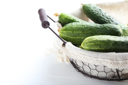 Fresh cucumbers on white wooden backgroundの写真素材