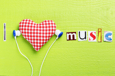 The word I love music in cut out magazine letters with earphonesの写真素材