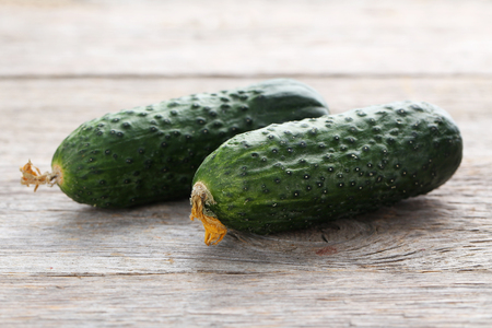 Fresh cucumbers on grey wooden backgroundの写真素材