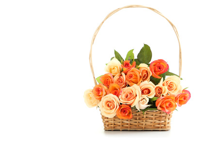 Bouquet of orange roses in basket isolated on whiteの写真素材