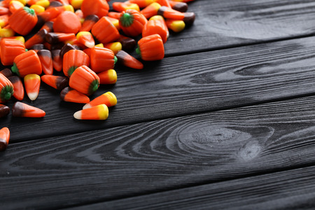 Halloween candy corns on black wooden backgroundの写真素材