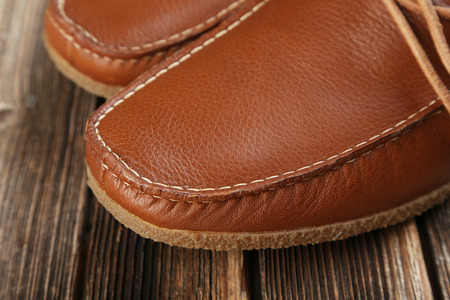 Fashion brown shoes on the wooden tableの写真素材