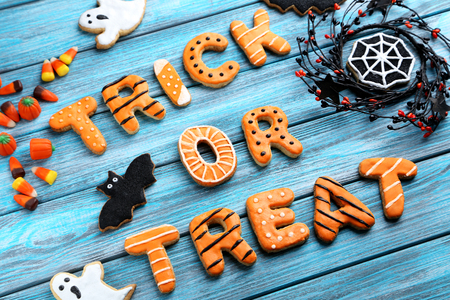 Fresh halloween gingerbread cookies on blue wooden tableの写真素材