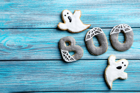 Fresh halloween gingerbread cookies on blue wooden tableの写真素材