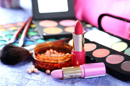 Makeup brush and cosmetics on a blue backgroundの写真素材