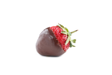 Fresh strawberries dipped in dark chocolate isolated on whiteの写真素材