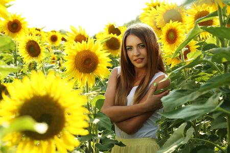 Beautiful girl in the sunflowers fieldの写真素材