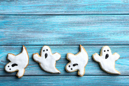 Fresh halloween gingerbread cookies on blue wooden tableの写真素材