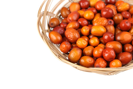 Ripe jujubes in basket on a white backgroundの写真素材