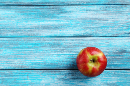 Fresh apple on a blue wooden tableの写真素材