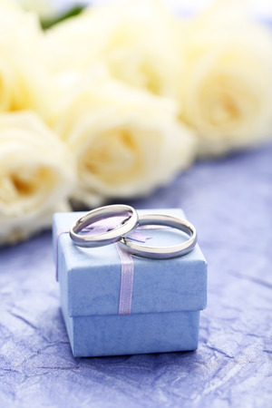 Silver wedding rings on a purple paper backgroundの写真素材