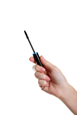Female hand with mascara for make-up isolated on whiteの写真素材
