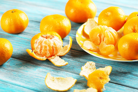 Ripe mandarins on a blue wooden tableの写真素材