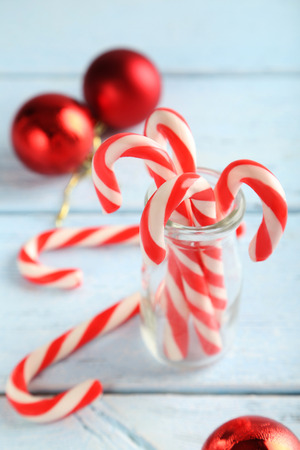 Christmas candy cane on a blue wooden tableの写真素材