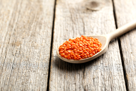 Red lentils on a grey wooden tableの写真素材