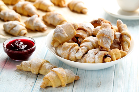 Fresh homemade croissants on a blue wooden tableの写真素材