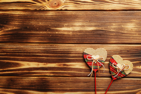 Love hearts on a brown wooden tableの写真素材