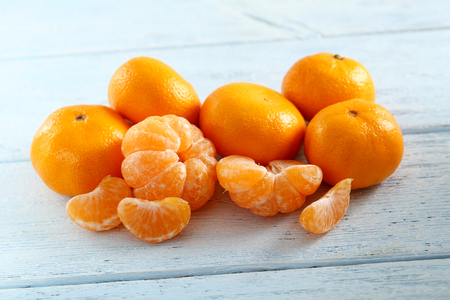 Ripe mandarins on a blue wooden tableの写真素材