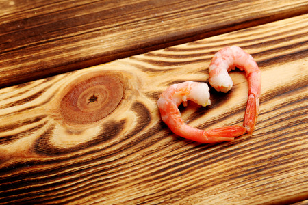 Fresh boiled shrimps on a brown wooden tableの写真素材