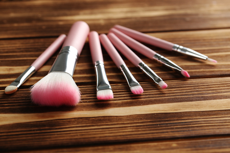 Makeup brush set on a brown wooden backgroundの写真素材